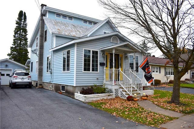 view of front of property with an outdoor structure and a garage