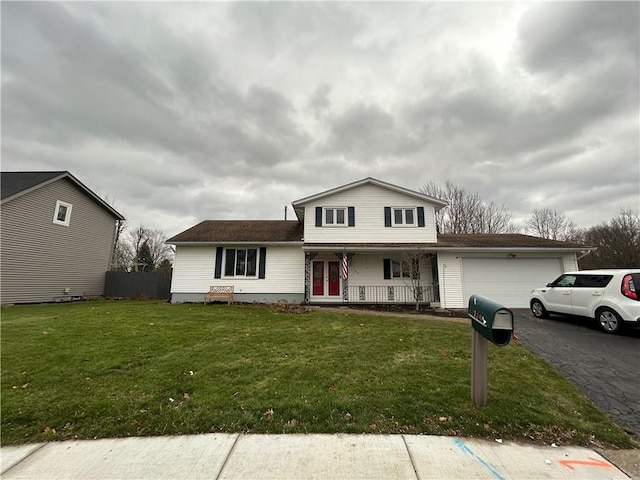 view of front of house with a front yard, a porch, and a garage