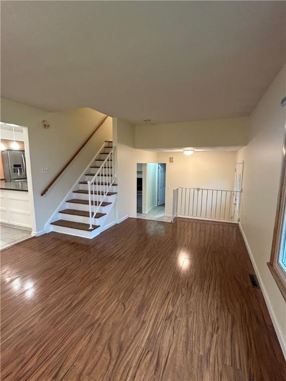 unfurnished living room with wood-type flooring