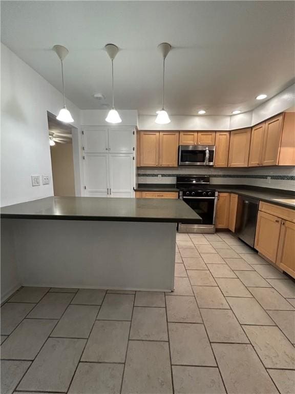 kitchen featuring kitchen peninsula, pendant lighting, dishwasher, range, and light tile patterned flooring