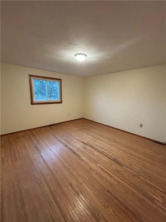 empty room with hardwood / wood-style flooring