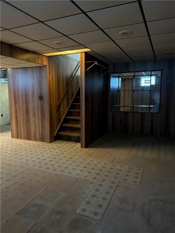 basement featuring wood walls