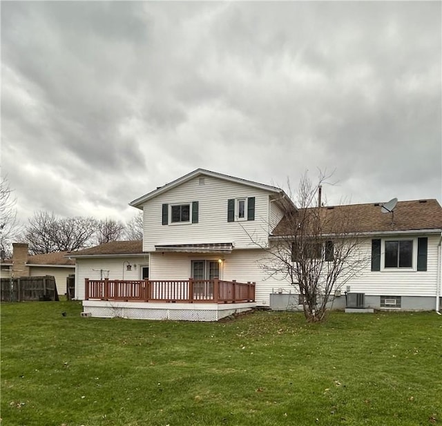 rear view of property featuring a deck, central AC unit, and a lawn