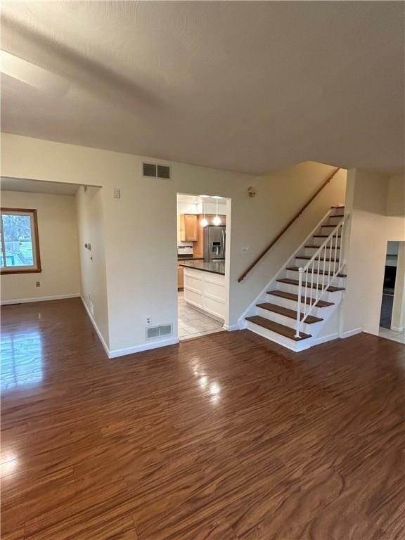 unfurnished living room with dark hardwood / wood-style flooring