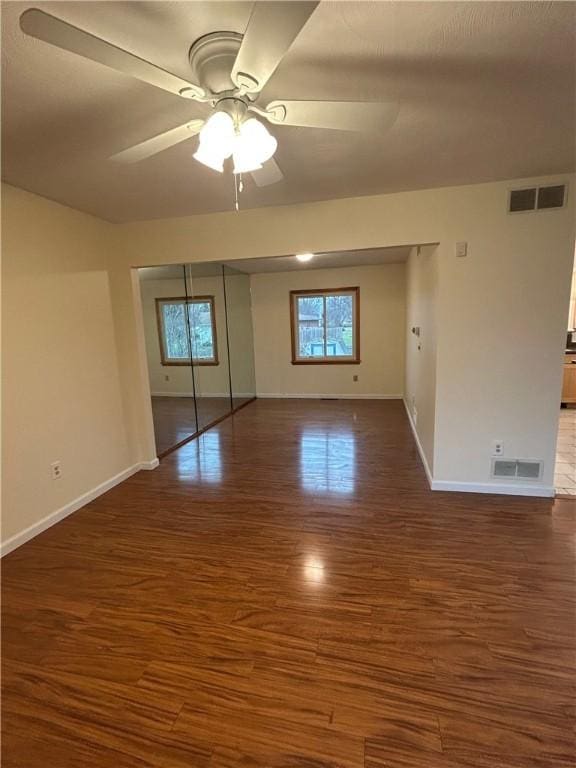 spare room with ceiling fan and dark wood-type flooring