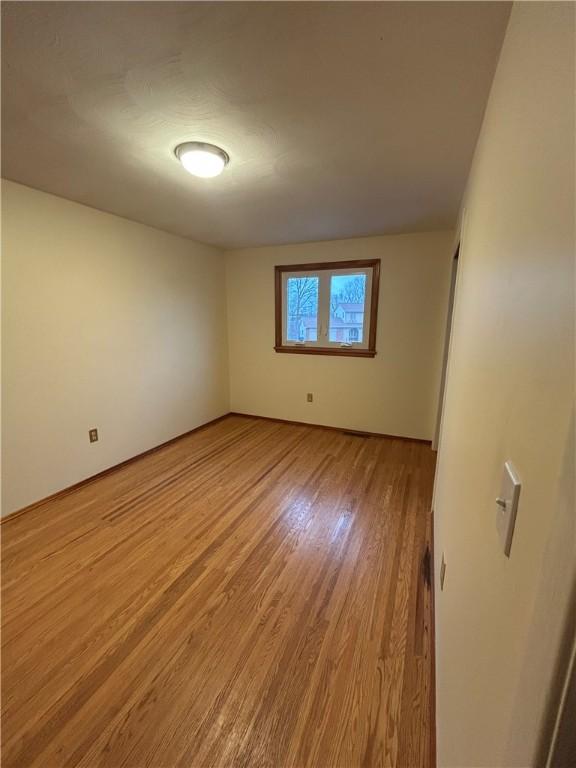 unfurnished room with light hardwood / wood-style floors