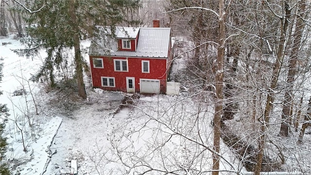 view of snowy exterior featuring a garage