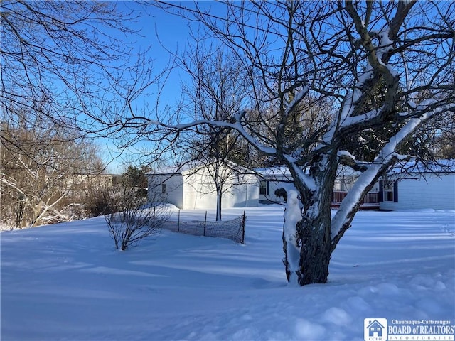 view of yard layered in snow