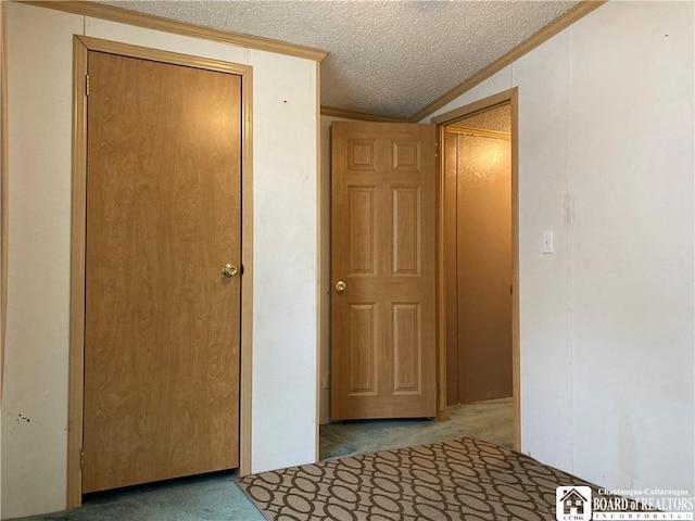 corridor featuring a textured ceiling, carpet floors, and vaulted ceiling