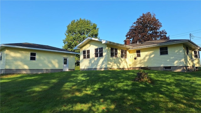 rear view of house featuring a yard