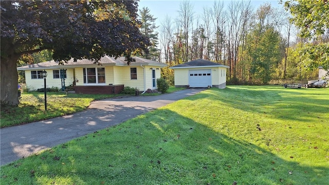 ranch-style home featuring an outbuilding, a garage, and a front lawn