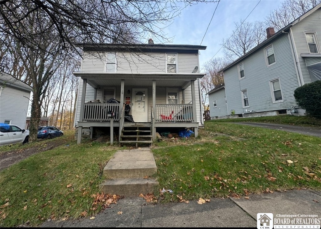 bungalow-style house featuring a porch and a front lawn