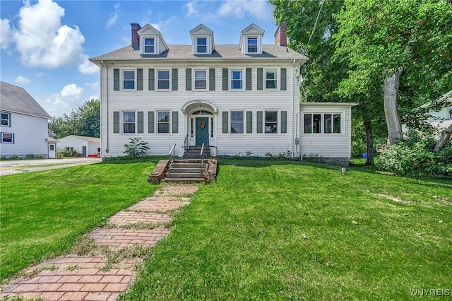 colonial inspired home featuring a front lawn