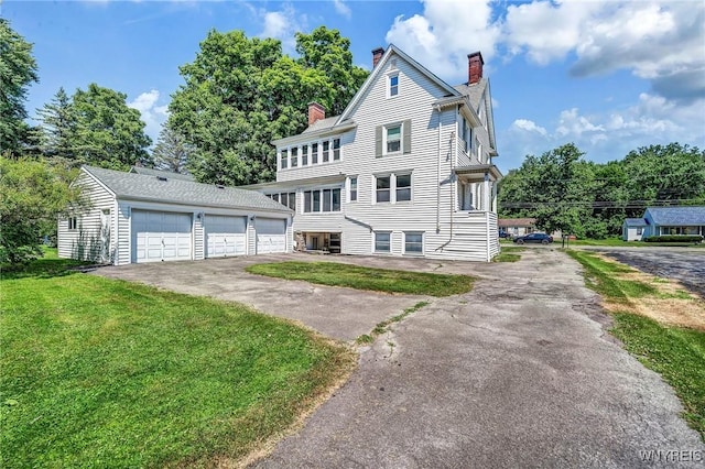 view of front of property featuring a garage and a front lawn