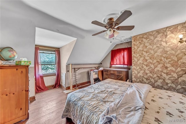 bedroom featuring light hardwood / wood-style floors, ceiling fan, and lofted ceiling