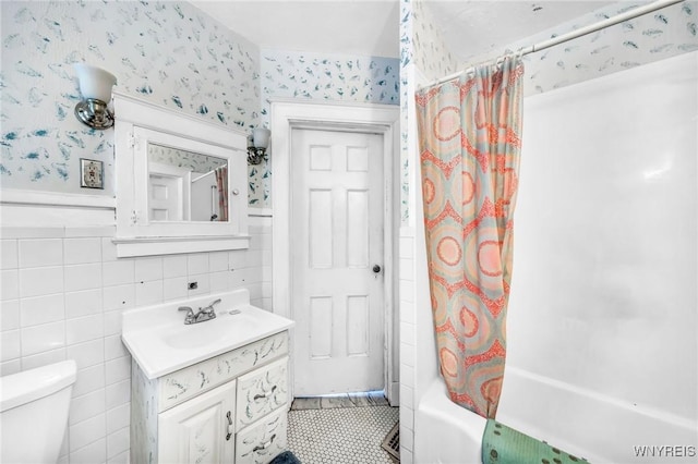 full bathroom with vanity, shower / bath combination with curtain, and toilet