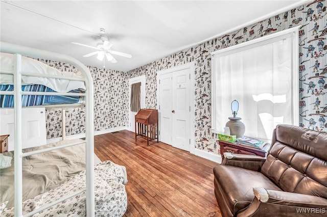 bedroom with ceiling fan and hardwood / wood-style floors