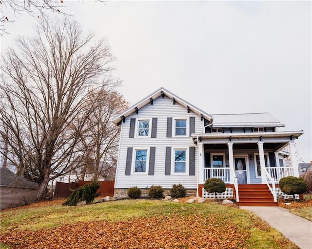 view of front of house featuring a porch and a front yard