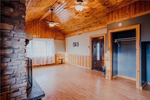 unfurnished living room with ceiling fan, wood ceiling, lofted ceiling, and light wood-type flooring