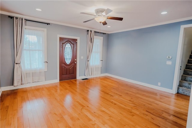 entryway featuring ceiling fan, light wood-type flooring, and ornamental molding