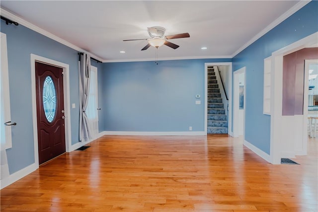 foyer featuring ceiling fan, light wood-type flooring, and crown molding