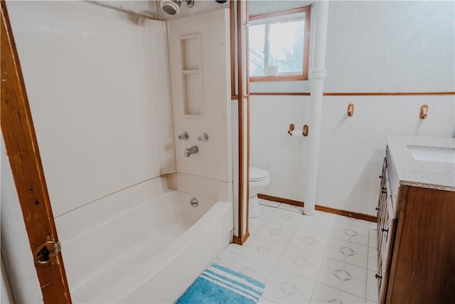 full bathroom featuring vanity, toilet, tile walls, and bathing tub / shower combination