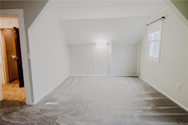 bonus room featuring carpet and vaulted ceiling