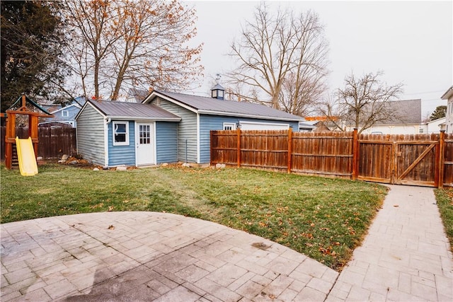 view of yard featuring a playground and a patio area