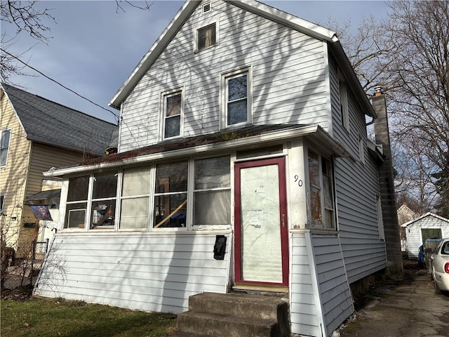 view of front of house with a sunroom