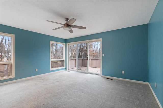 spare room featuring carpet flooring and ceiling fan