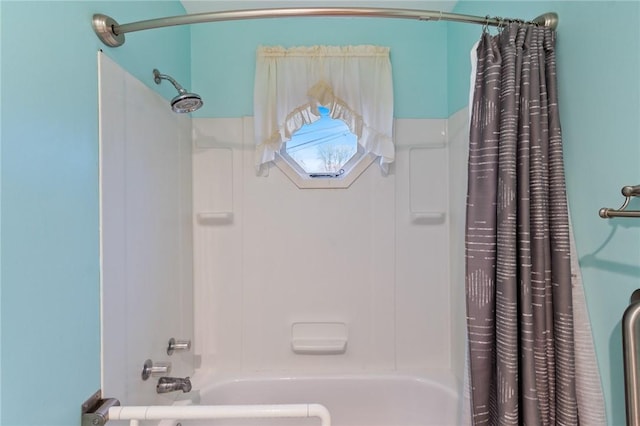 bathroom with shower / bath combo with shower curtain