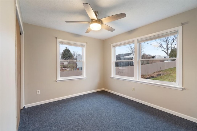 carpeted empty room featuring ceiling fan