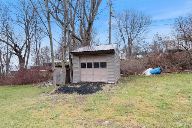 view of outbuilding with a lawn and a garage