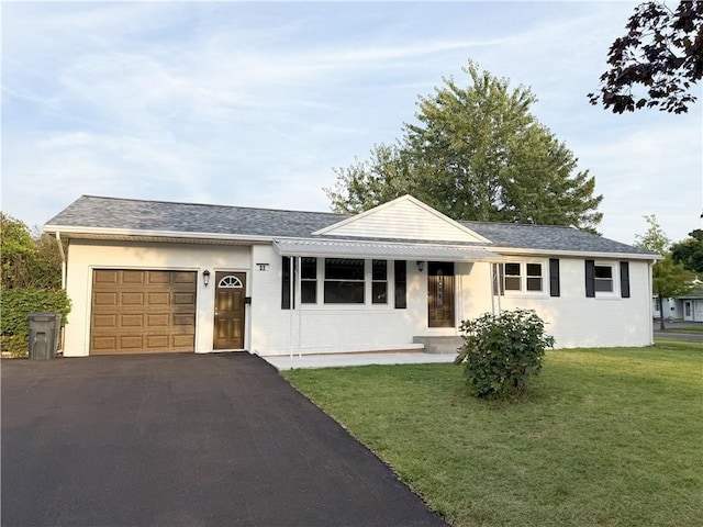 ranch-style house featuring a garage and a front yard