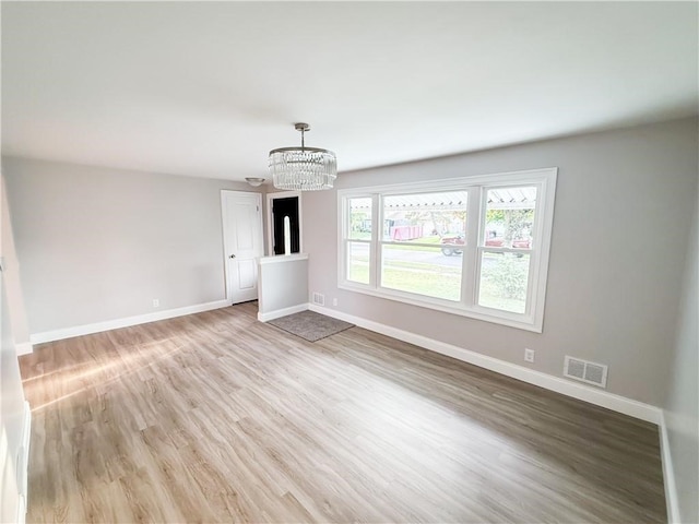 interior space featuring a chandelier and hardwood / wood-style floors