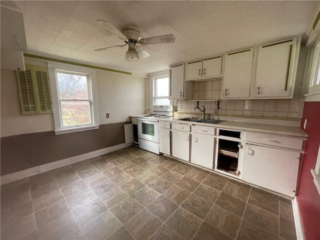 kitchen featuring white electric range oven, ceiling fan, decorative backsplash, and sink