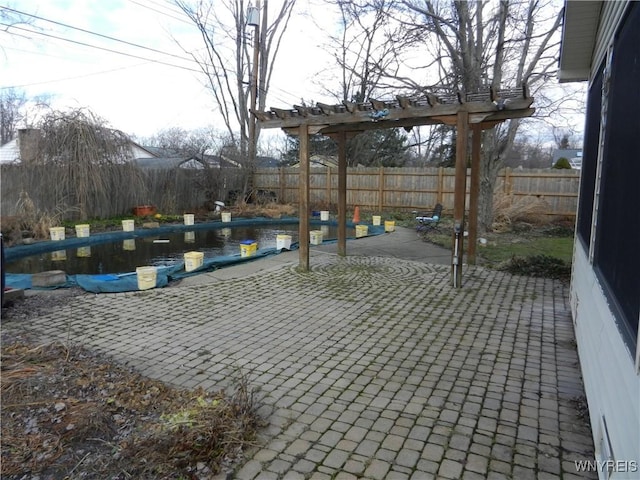 view of patio / terrace featuring a pergola and a fenced in pool