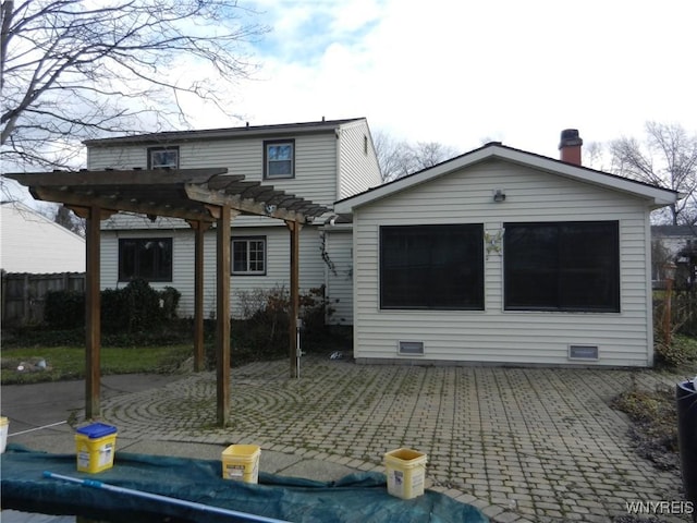 rear view of house featuring a pergola