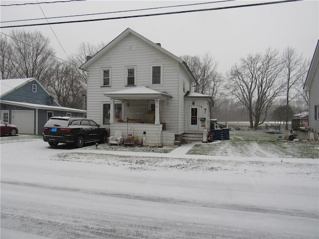 view of front property with a garage and an outbuilding