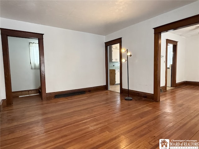 spare room featuring wood-type flooring