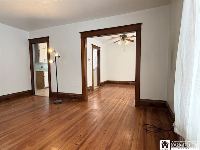 unfurnished room with hardwood / wood-style floors and ceiling fan