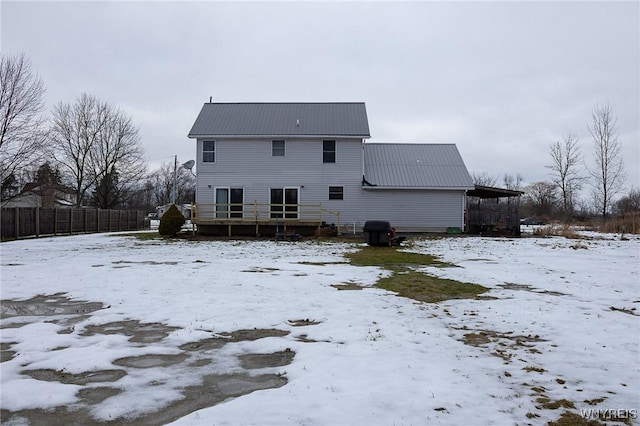 view of snow covered rear of property