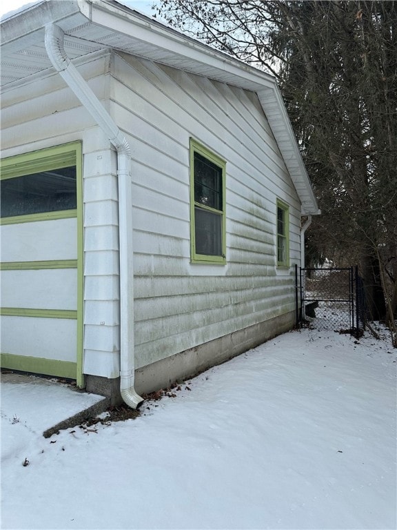 snow covered property featuring a garage