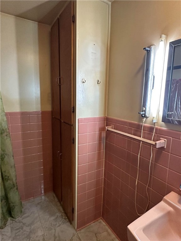 bathroom with tile walls