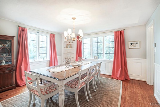 dining room with light hardwood / wood-style floors and a chandelier