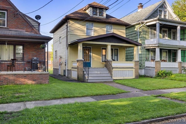 view of front of property with covered porch and a front lawn