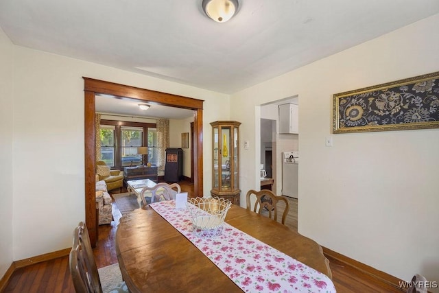 dining space with dark hardwood / wood-style flooring