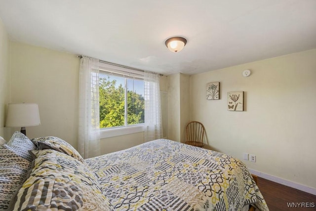 bedroom with dark wood-type flooring