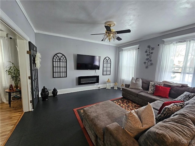 living room with a wealth of natural light, crown molding, and ceiling fan