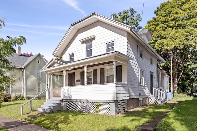 view of front of house with covered porch and a front lawn